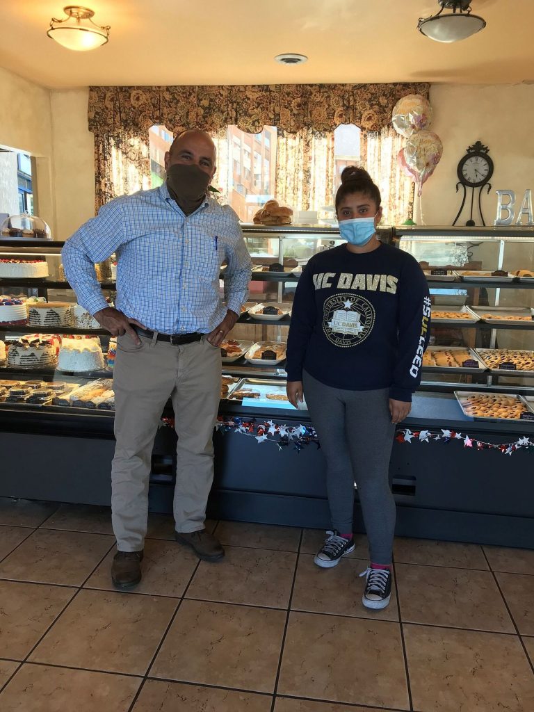 The Great Handover: Family Firms Face a Succession Crunch Two generations of a family standing together inside their bakery